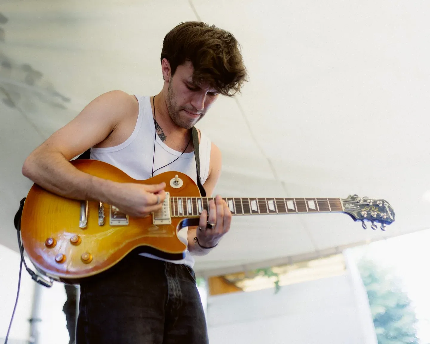 Serban Calugar playing electric guitar on stage